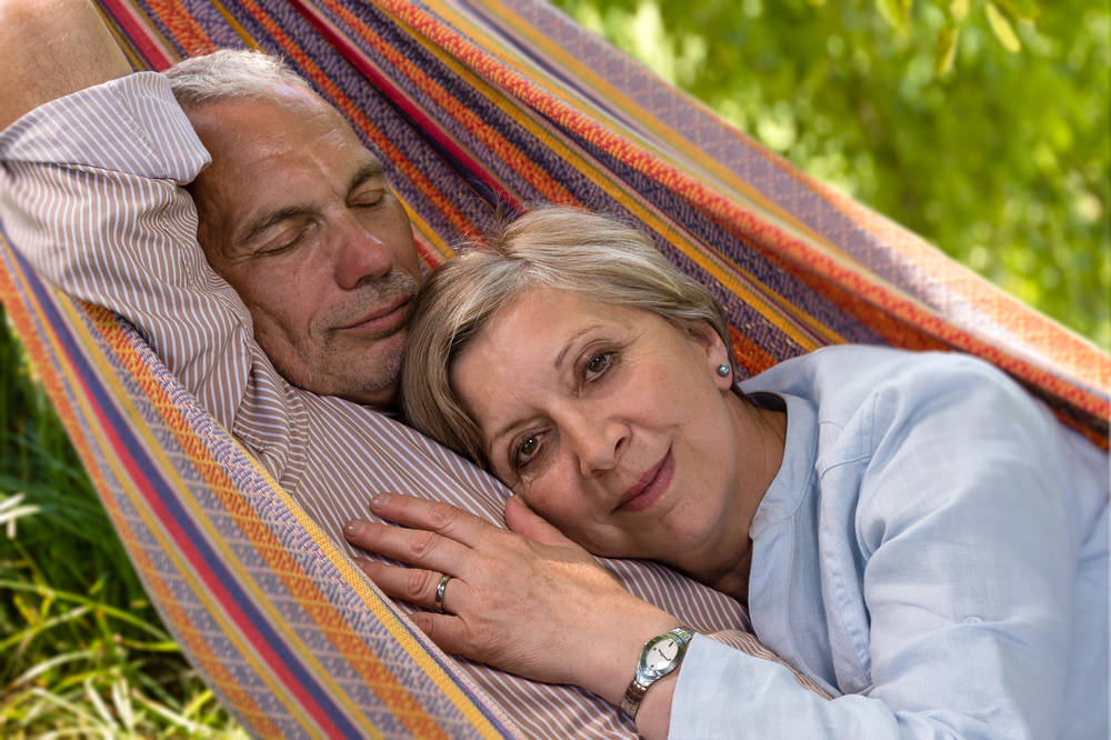 man and woman relaxing in hammock