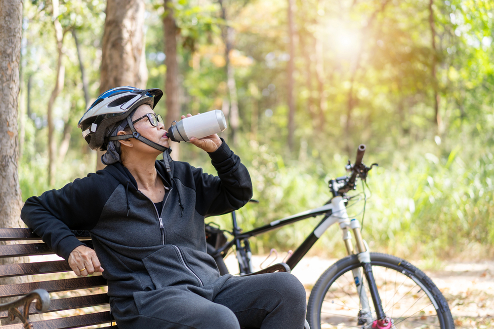 woman drinking water in the park