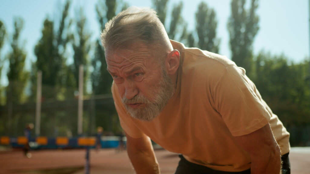 Senior breathing heavily after training physical activity